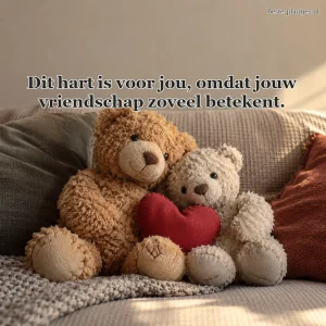 Twee versleten knuffelberen zitten met een rood stoffen hart op de bank.